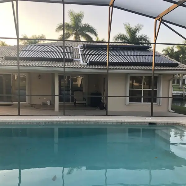 Screened canal pool with rooftop solar panels