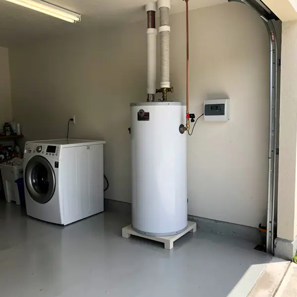Solar water storage tank beside garage washer